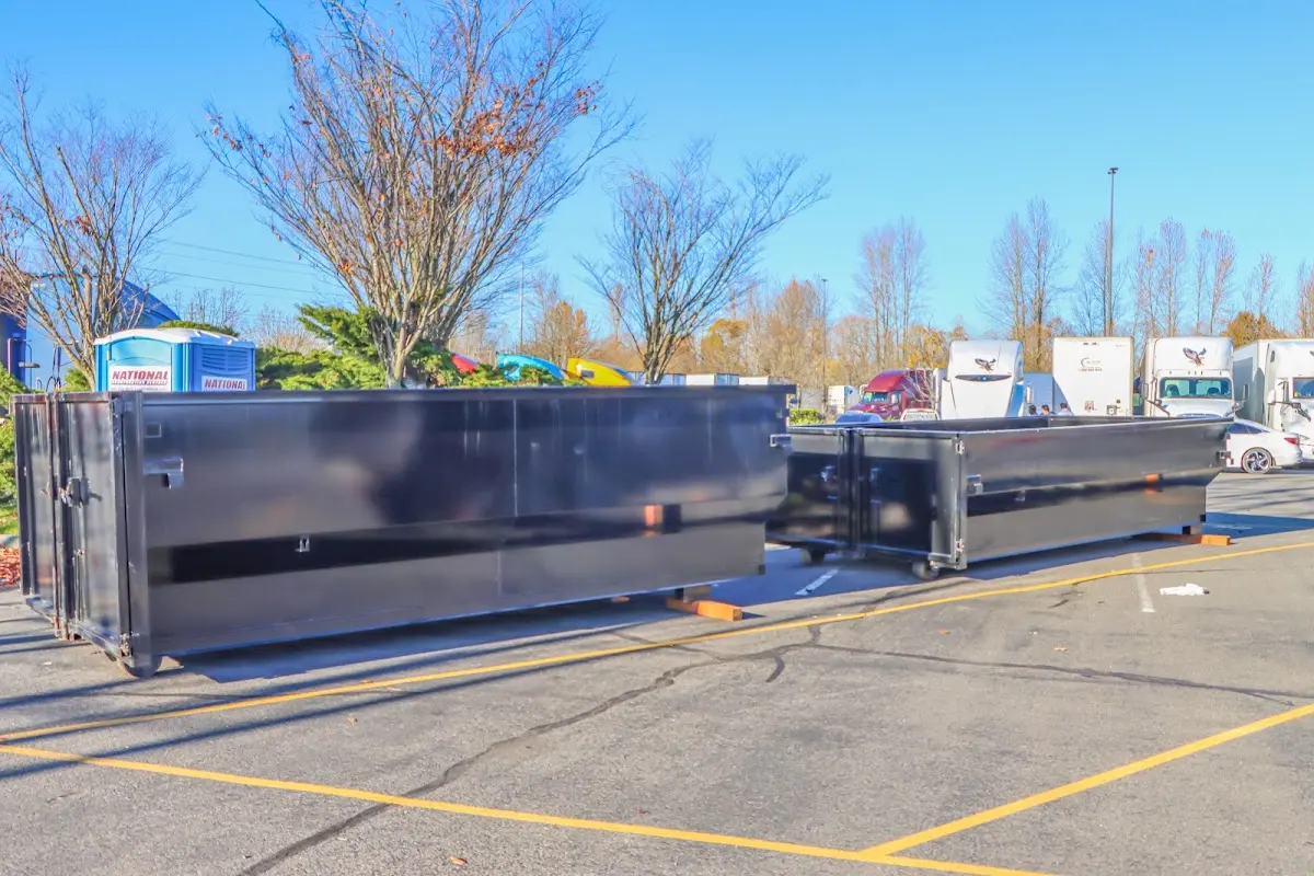 Professional dumpster rental service with roll-off container on residential driveway in Lady Lake